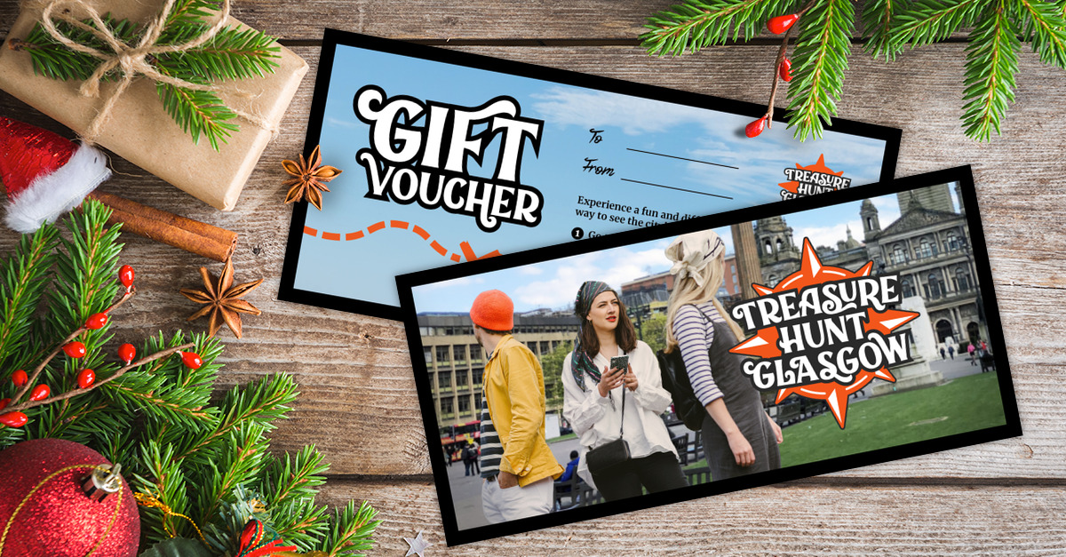 A gift voucher for Treasure Hunt Glasgow on a table covered with Christmas decorations