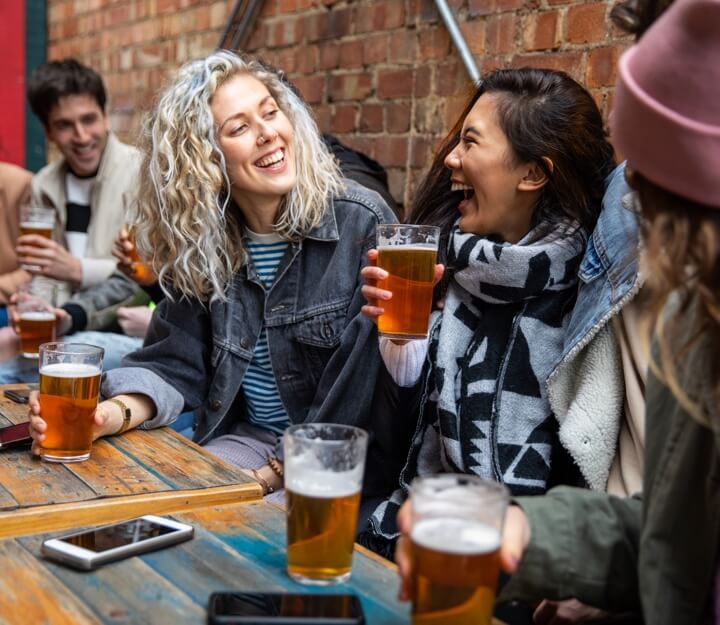 Friends enjoying a drink together while playing Treasure Hunt Glasgow