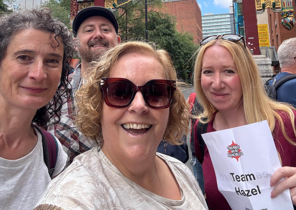 Team smiling during a city treasure hunt for a work social