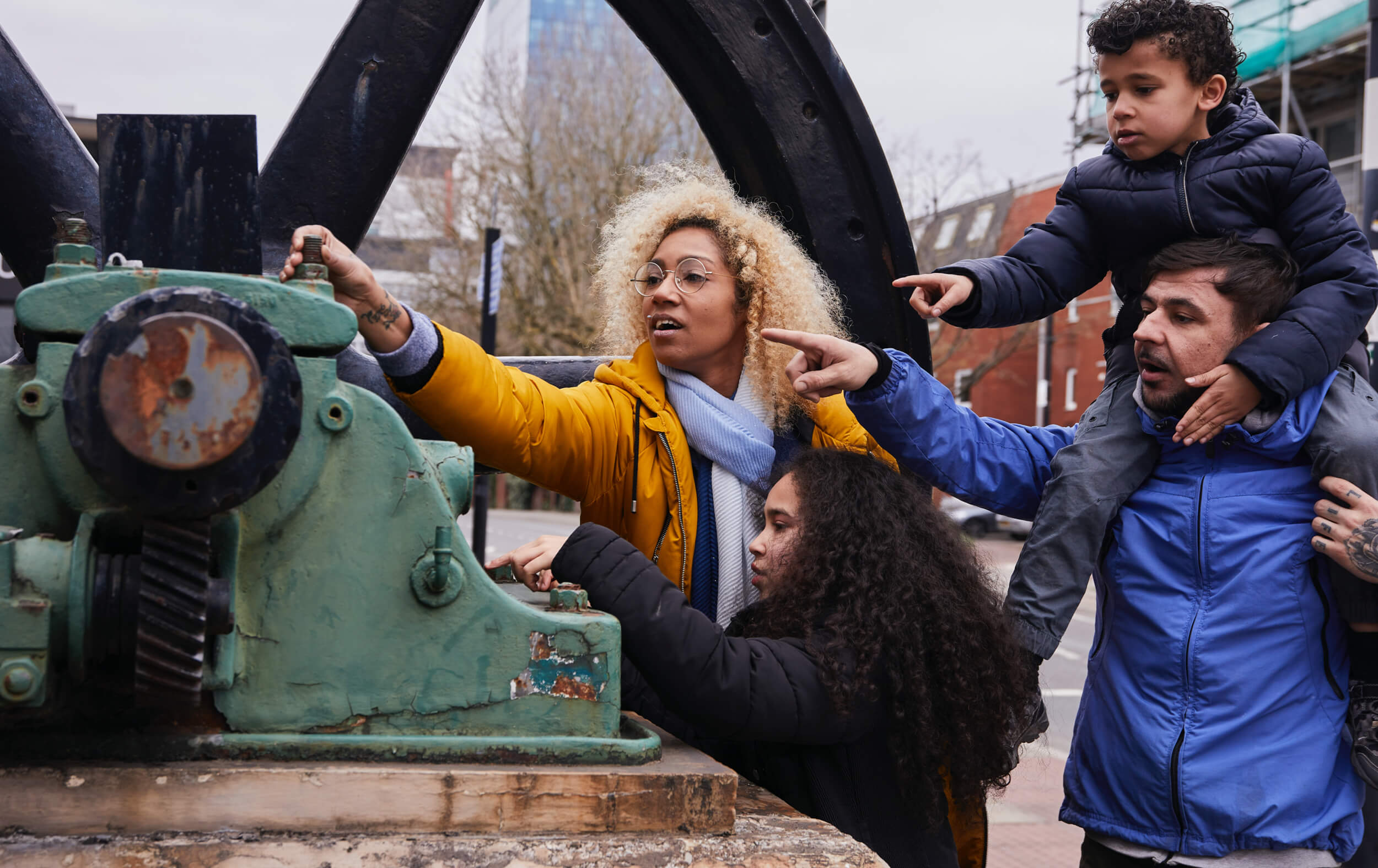 A family inspecting a piece of machinery on a treasure hunt