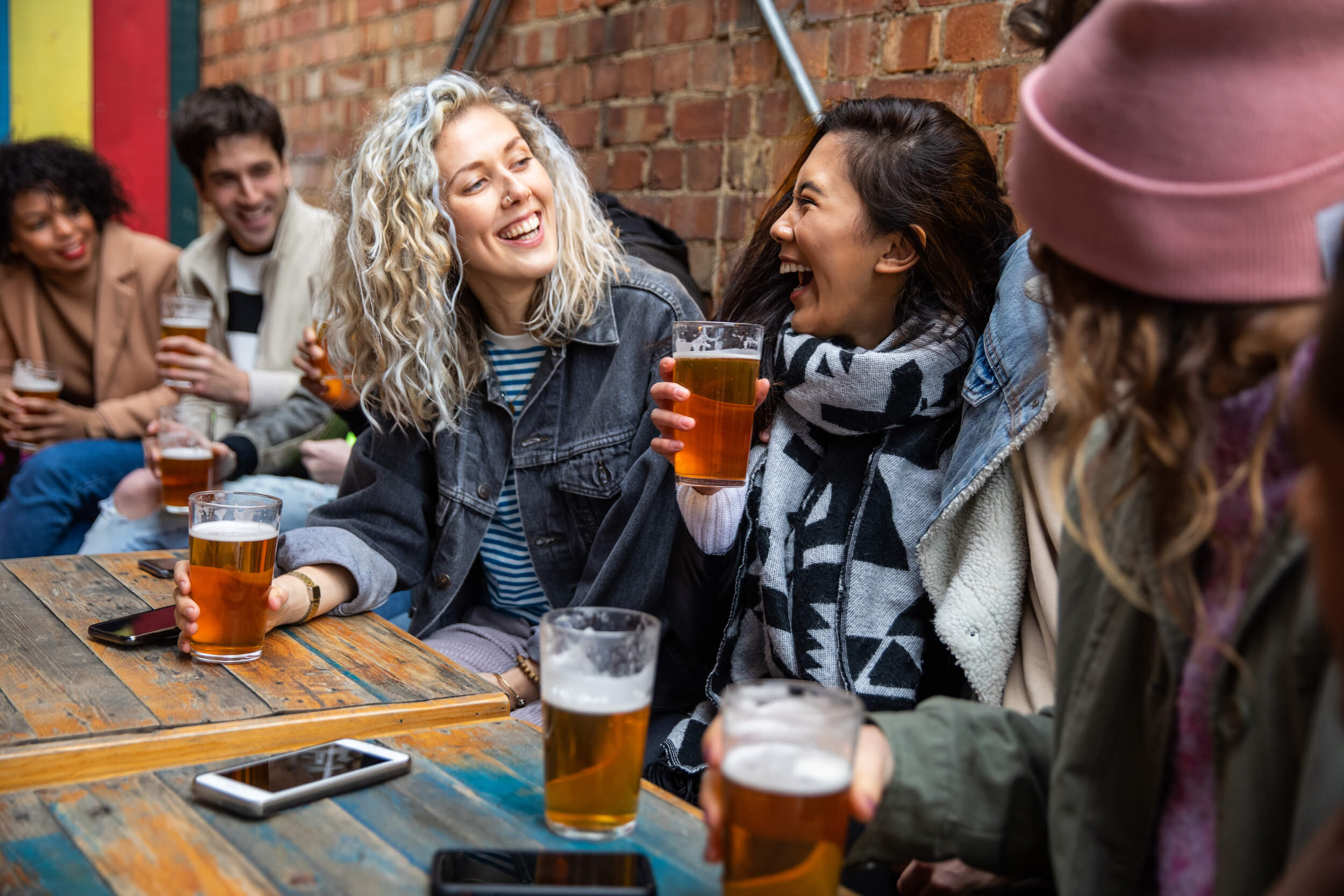 A group of hens together in the pub, taking a break from playing {{< param 